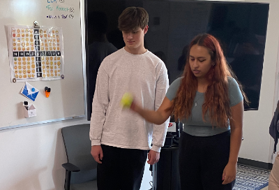 Student holding tennis ball during Peer Collaborator training activity