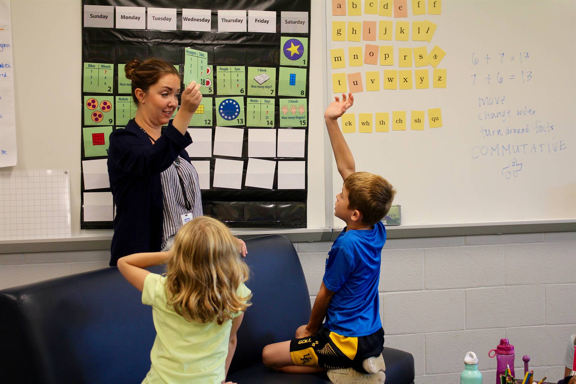 A teacher showing a daily workout card from Number Corner to the class