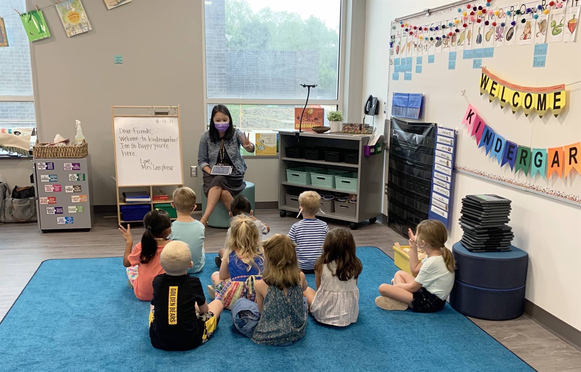A kindergarten teacher leading small group instruction