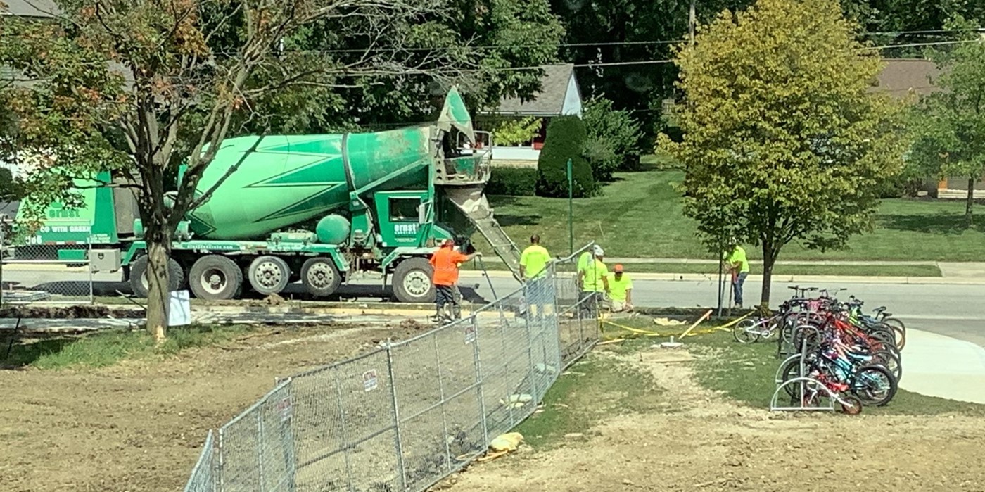 Workers laying new playground sidewalk at Wickliffe
