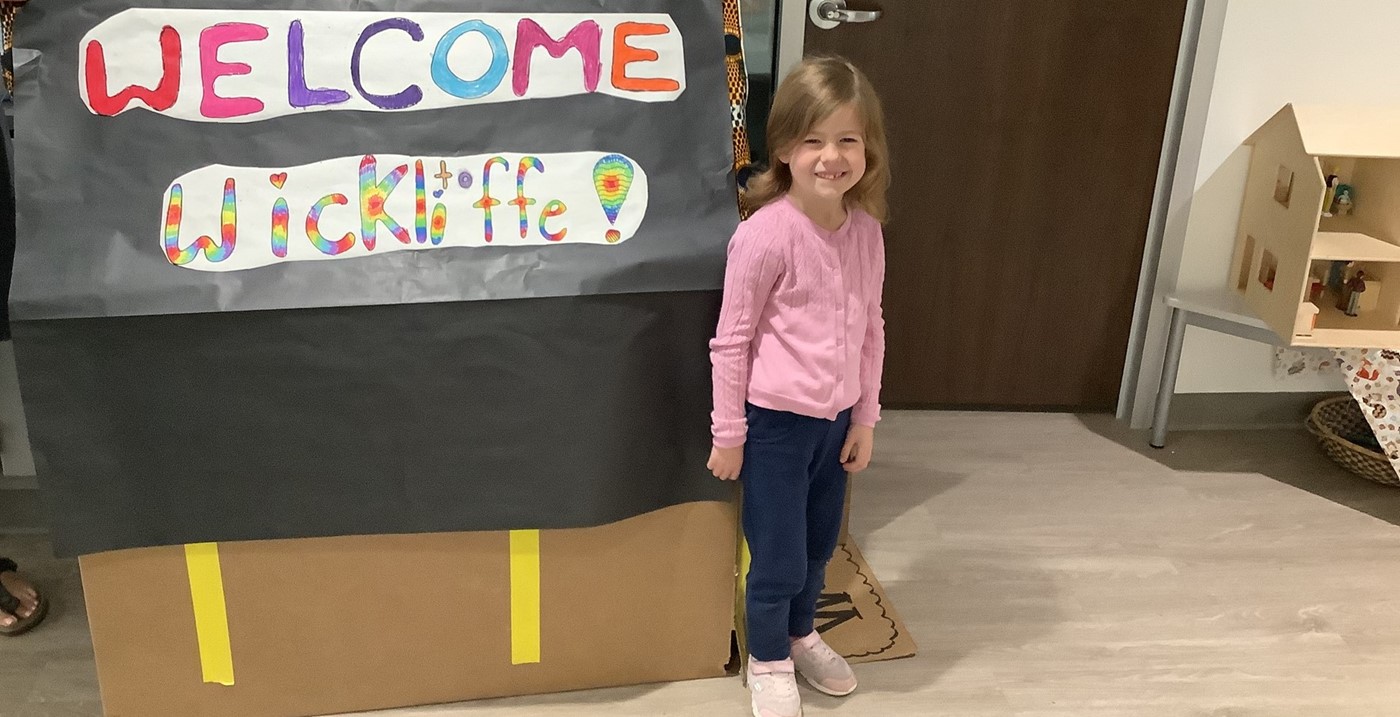 Kindergarten student with &#34;Welcome to Wickliffe&#34; sign