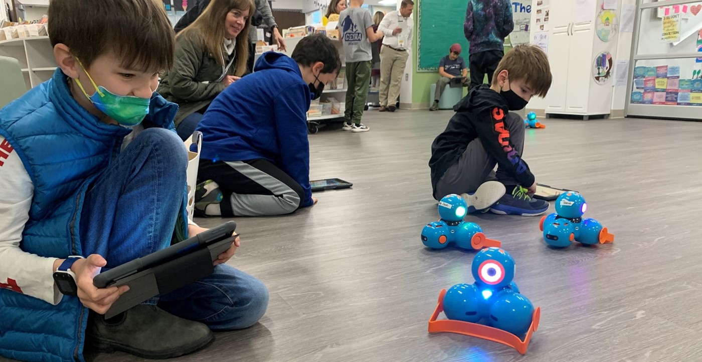 Elementary students learning to code robots