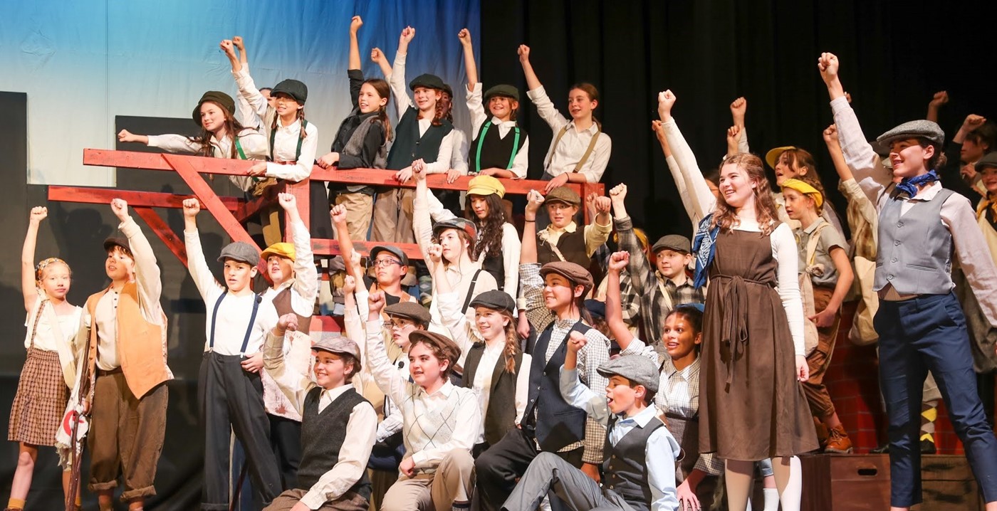 The cast of the Jones Fall Production of Newsies Jr on stage