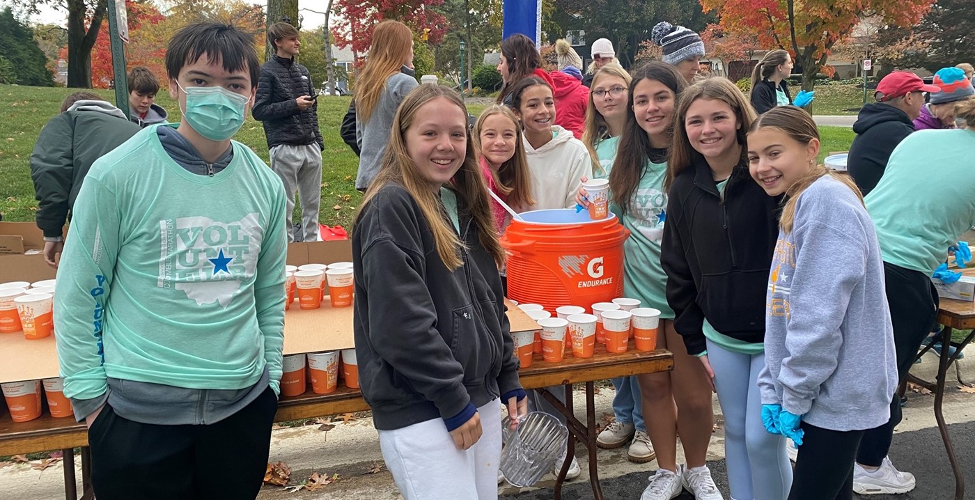 A group of students volunteering at a water station for the Columbus Marathon