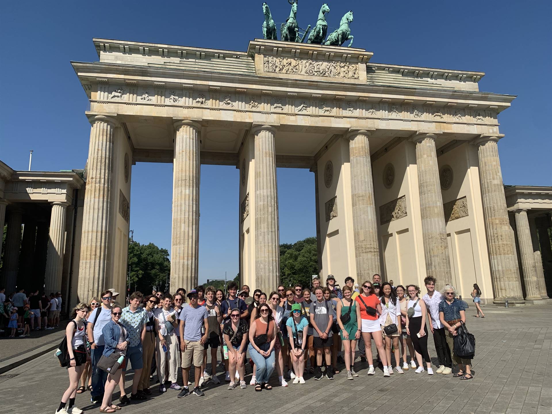 A group of students gathered in front of the Brandenburg Gate